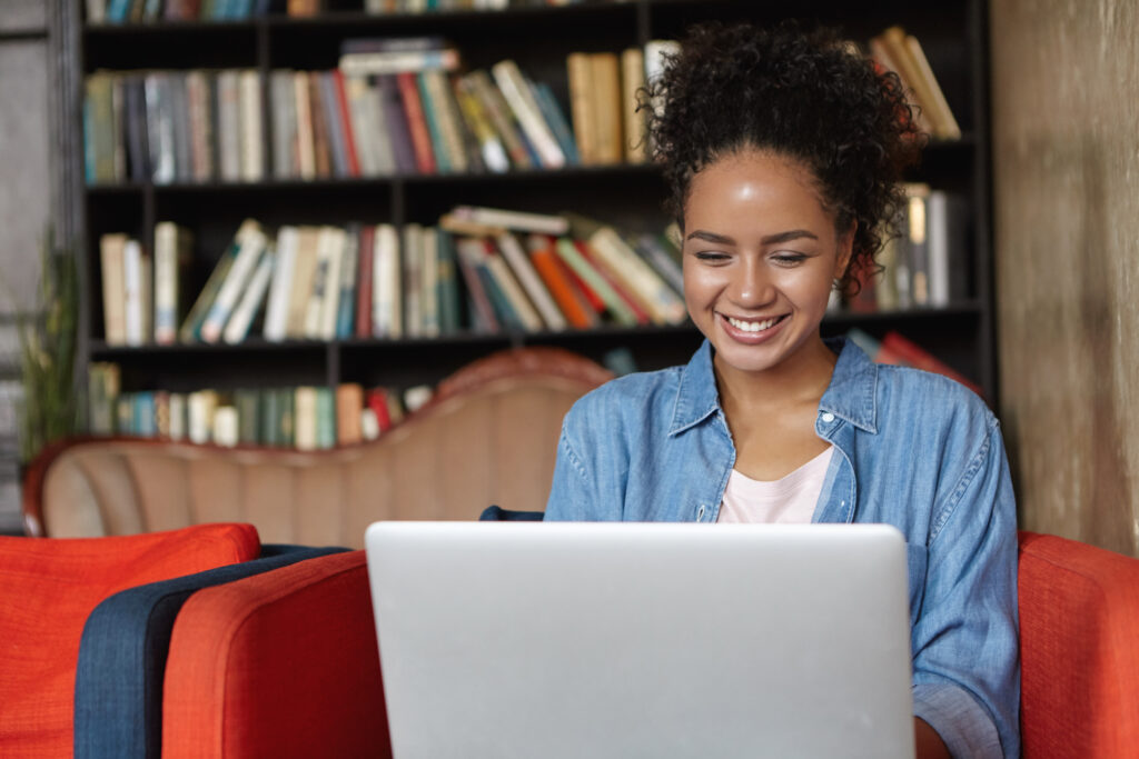 woman sitting library with her laptop